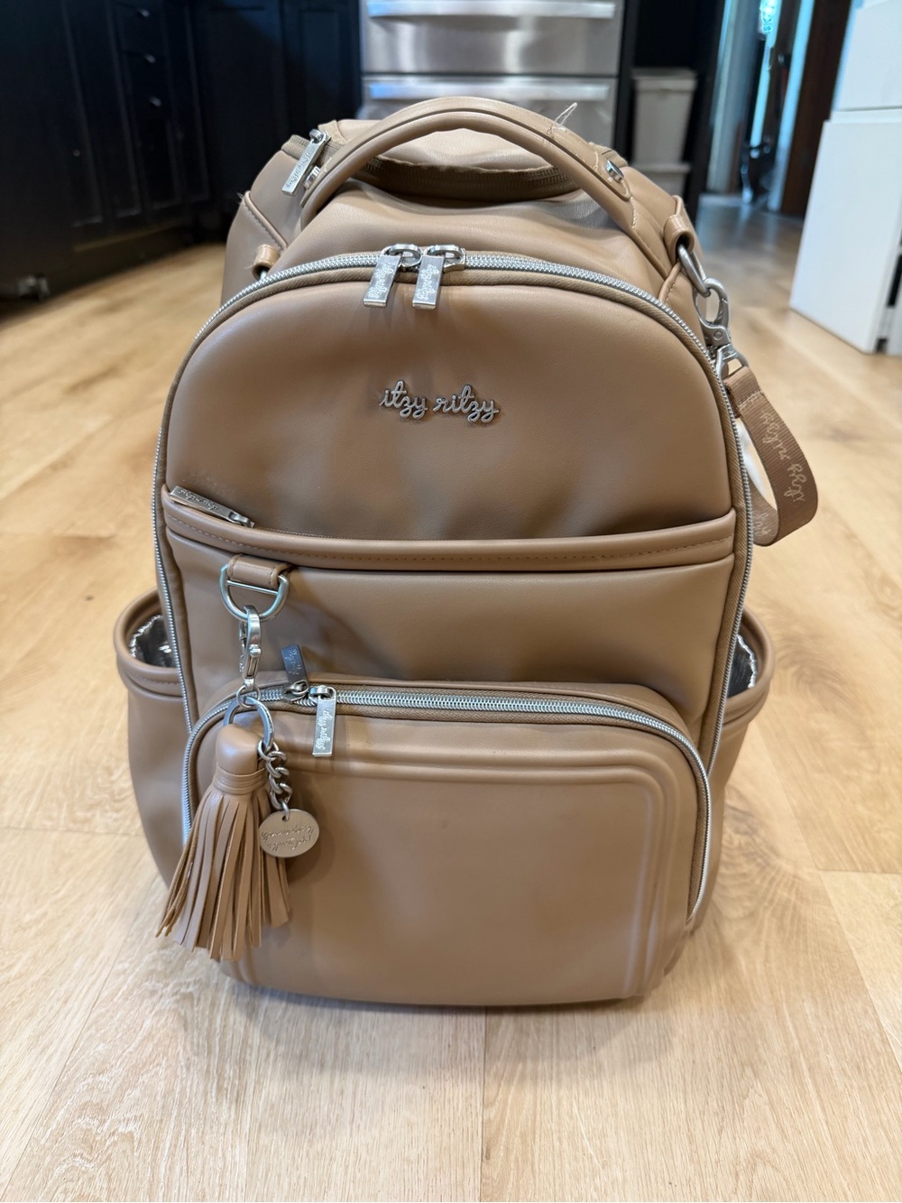 Itzy Ritzy Tan Diaper Backpack with Tassel